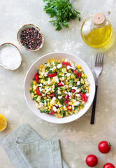 Pasta salad with tomatoes, zucchini, corn and feta cheese. Healthy eating. Vegetarian food.