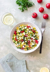 Pasta salad with tomatoes, zucchini, corn and feta cheese. Healthy eating. Vegetarian food.