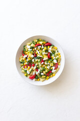 Pasta salad with tomatoes, zucchini, corn and feta cheese. Healthy eating. Vegetarian food.
