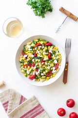 Pasta salad with tomatoes, zucchini, corn and feta cheese. Healthy eating. Vegetarian food.