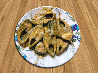 Fried Hilsa Fish on Plate with Wooden Table Background