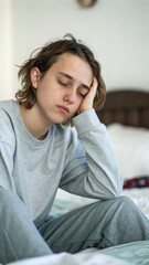 Young person with tired eyes sitting at home