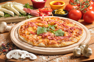 Fresh Homemade Pizza with Ham, Cheese, and Vegetables on Rustic Wooden Table