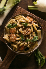 Italian pasta with shrimp and basil on plate, gourmet seafood dish