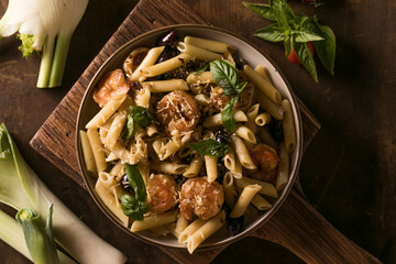 Italian pasta with shrimp and basil on plate, gourmet seafood dish