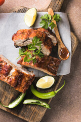 BBQ grilled ribs with vegetables on rustic table, delicious barbecue meal