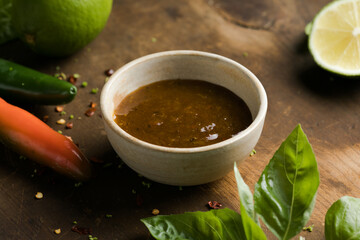 picy sauce with chili, lime, green tomato and tomatillo on rustic table