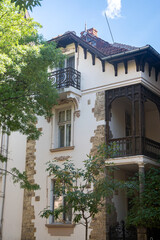 An ornate facade of an old European house with a beautiful balcony, wooden details, and rustic charm