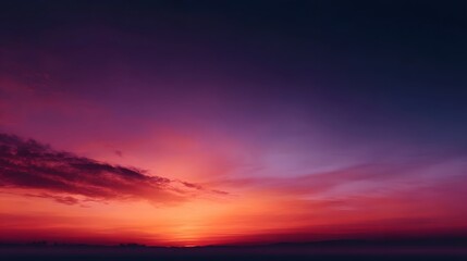 Obraz premium Vibrant and colorful sky during sunset featuring a dramatic gradient of purple red and orange hues with soft clouds along the serene horizon