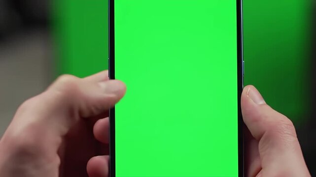 Person Holding Smartphone with Green Screen &mdash; Mobile App Mockup for Video Compositing