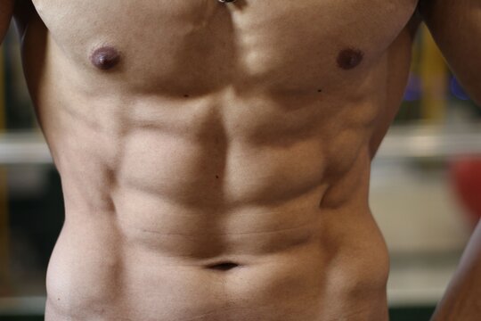Muscular male torso with defined abs.