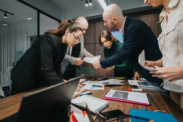 Group of employees engaged in an intense discussion, collaborating on work tasks in a modern office...