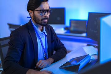 Stressed IT professional reacts with shock to a critical system error on his computer. A developer...