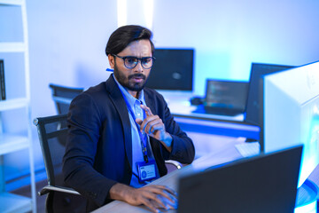 Stressed IT professional reacts with shock to a critical system error on his computer. A developer...