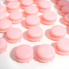Obraz premium Rows of delicate pink macarons with smooth rounded tops and delicate feet, arranged in a visually appealing pattern on a pristine white background, with soft natural light accentuating the subtle