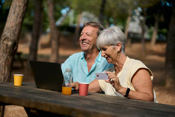 Mature couple enjoying outdoor work session in nature