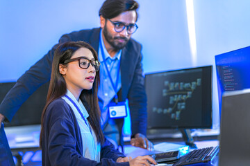 AI engineer developing algorithms in a futuristic data center. The blue light reflects innovation...