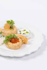 Close-up of gourmet pancakes with red caviar