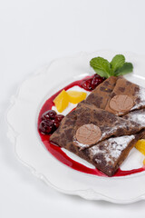 Close up of chocolate pancakes with fruits and chocolate
