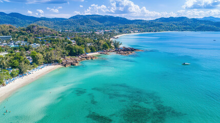 Aerial view of serene beach with turquoise waters, sandy shores, and lush green hills in background, perfect for relaxation and travel