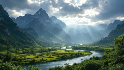 Winding river through green valley with mountains and sun rays breaking through the clouds above it