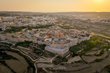 An aerial view of Mdina, the historic fortified city in Malta, surrounded by ancient stone walls...