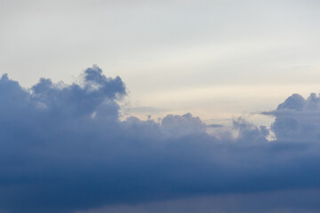 Stormy, ominous sky with dark blue and gray clouds. A dramatic, cloudy background for weather,...