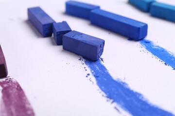 Colorful chalk pastels on white background, closeup