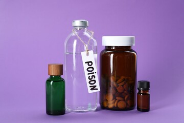 Glass bottles with poisons on violet background