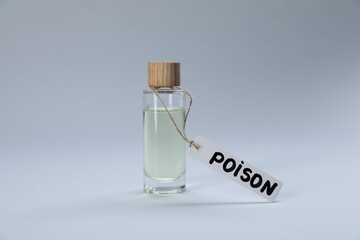 Bottle with poison on light grey background