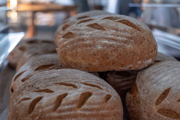 Fresh baked whole-grain bread rolls stacked together, showcasing crispy crust, soft texture, and rustic appearance, perfect for bakery displays and delicious food presentations
