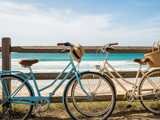 Fototapeta premium Leisurely bike ride along the coast with a scenic beach and ocean backdrop