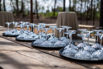 Elegant champagne glasses arranged on decorative trays, showcasing intricate designs, perfect for wedding celebrations and stylish parties with a touch of sophistication and joy