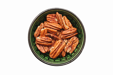 Green bowl filled with pecan nuts isolated on white background. Healthy snack rich in protein and nutrition. Organic natural dry food served in traditional decorative ceramic bowl.