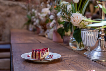 Elegant cheesecake dessert beautifully presented on a rustic wooden table, surrounded by floral...