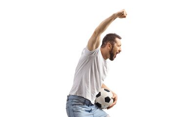 Profile shot of a young man with a football cheering and gesturing with hand
