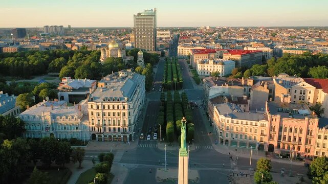 Riga, Latvia, Baltics. Beautiful panoramic aerial 4K video from flying drone to Freedom Square with the Latvia Freedom Monument at the summer sunset. (Series)