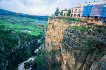 Dramatic view of Ronda Spain with cliffside buildings and deep gorge carved by Rio Guadalevin