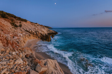 Fototapeta premium Coastal Landscape with Secluded Beach among Rocky Cliffs