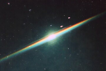 A single, vibrant rainbow is seen in the sky at night, casting its colors across an endless expanse of dark blue space.