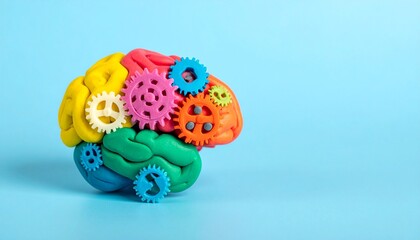 This conceptual image features a handcrafted brain model sculpted from vibrant clay, segmented into anatomically inspired regions using bold colors such as red, green, yellow, and purple. Interspersed