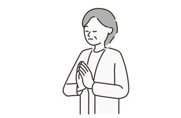 合掌する年配の女性