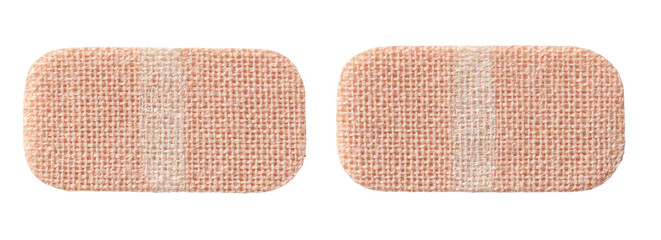 Two light beige rectangular adhesive bandages