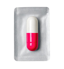 A single, pink and white capsule nestled in a clear plastic blister pack