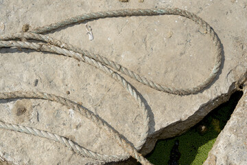 old grungy rope outdoors on stone © eugen