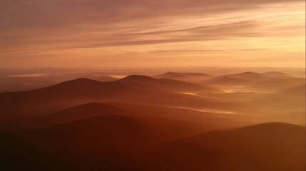 Early morning mountainous landscape with rolling hills covered in dense fog,