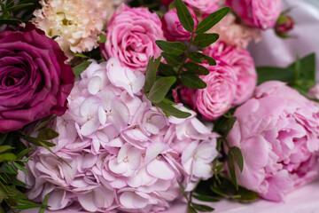 Pink flowers, close-up. Floral background of beard and pink buds for a flower shop. Wedding bouquet of soft pink roses, peonies, eustoma and hydrangea with floristic greenery