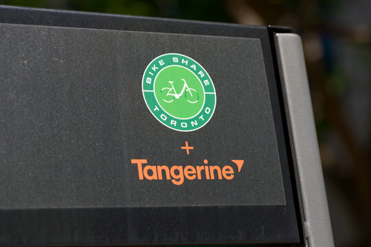 close-up of Tangerine Financial and Bike Share Toronto logos outdoors