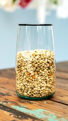Clear glass vase filled with light-colored grains