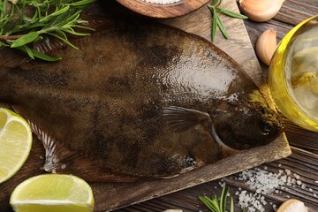 Fresh flounder fish, salt and products on wooden table, flat lay. Raw seafood